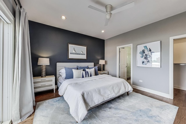 bedroom with baseboards, wood finished floors, recessed lighting, a ceiling fan, and ensuite bathroom