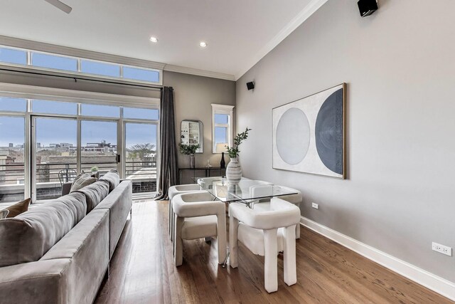 dining area featuring baseboards, crown molding, wood finished floors, and recessed lighting