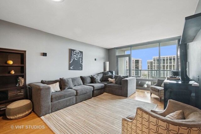 living room featuring floor to ceiling windows and wood finished floors