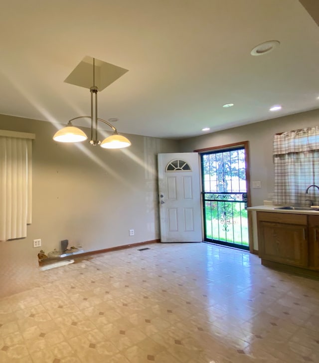 foyer with light flooring, baseboards, and recessed lighting