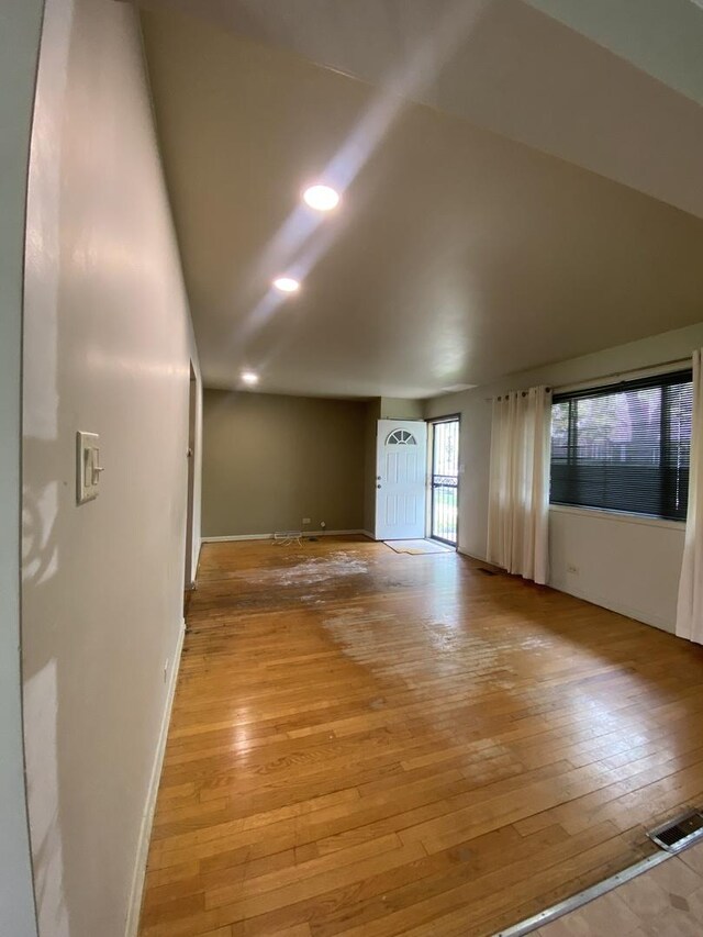 unfurnished room with light wood finished floors, baseboards, and recessed lighting