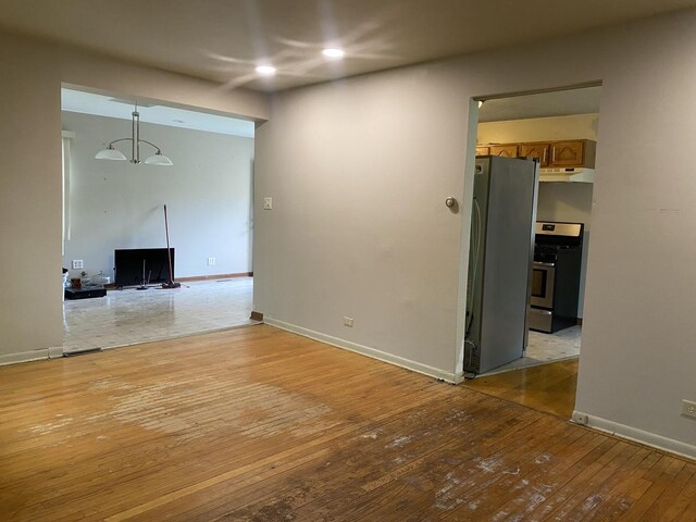 unfurnished living room featuring light wood finished floors, recessed lighting, and baseboards