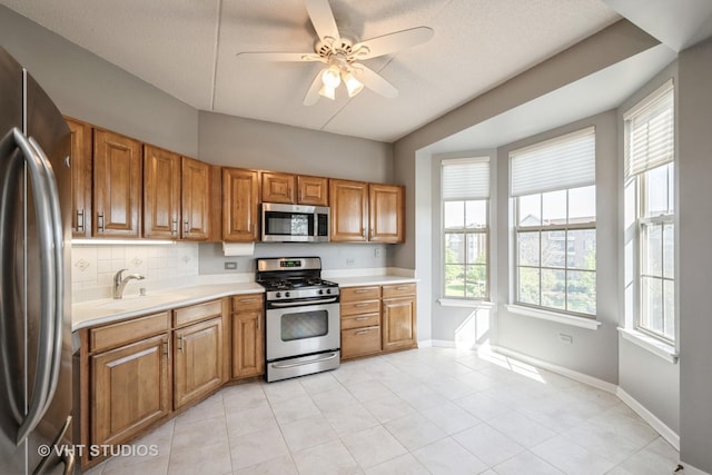 3115 Town Square Dr Unit 303, Rolling Meadows, IL 60008 - kitchen featuring stainless steel appliances, a sink, light countertops, baseboards, and a ceiling fan