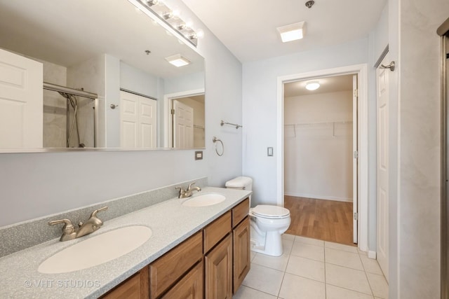 3115 Town Square Dr Unit 303, Rolling Meadows, IL 60008 - full bath featuring tile patterned flooring, double vanity, an enclosed shower, toilet, and a walk in closet