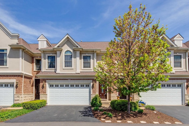 893 S Plum Grove Rd, Palatine, IL 60067 - townhome / multi-family property with asphalt driveway, a garage, and stucco siding