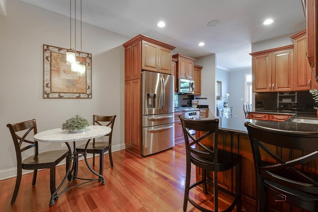 893 S Plum Grove Rd, Palatine, IL 60067 - kitchen with stainless steel appliances, a breakfast bar, light wood-type flooring, recessed lighting, and a peninsula