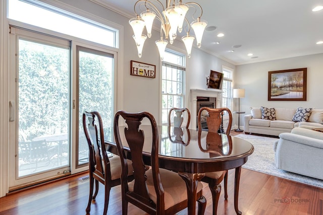893 S Plum Grove Rd, Palatine, IL 60067 - dining space with wood finished floors, crown molding, a chandelier, a fireplace, and recessed lighting