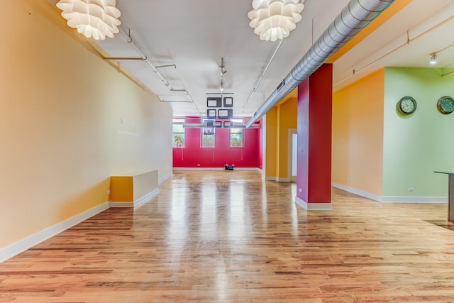 interior space featuring wood finished floors and baseboards