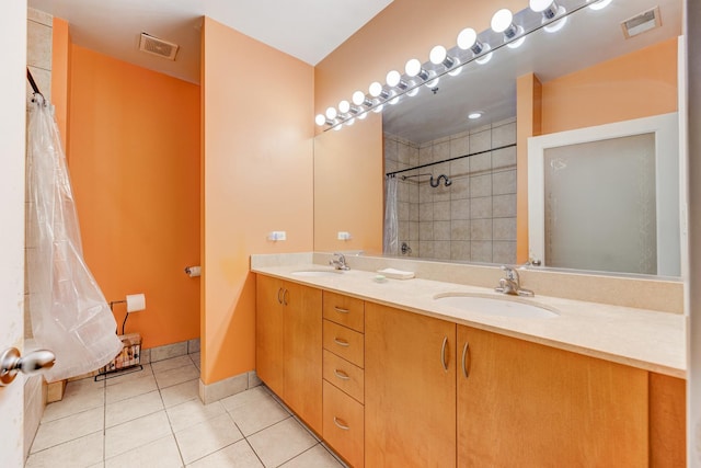 full bathroom with a sink, tile patterned flooring, visible vents, and a tile shower