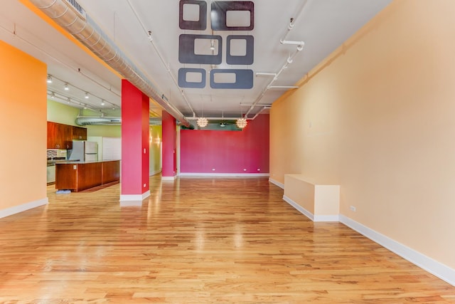 empty room with light wood-style flooring and baseboards