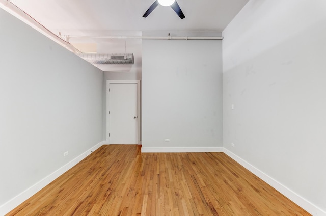 spare room with light wood-type flooring, visible vents, baseboards, and a ceiling fan