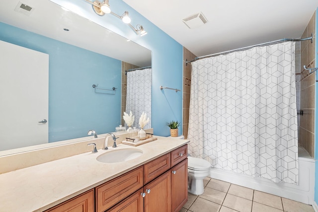 bathroom featuring toilet, tile patterned flooring, vanity, and shower / bath combo with shower curtain