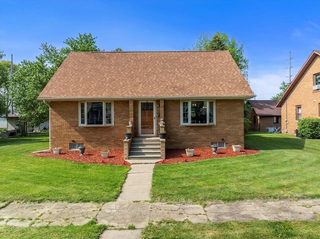 304 W Elm St, Fairbury, IL 61739 - view of front facade featuring brick siding, a front yard, and roof with shingles