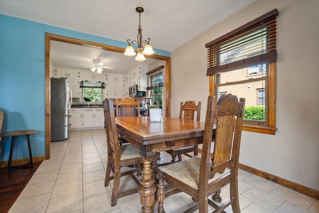 304 W Elm St, Fairbury, IL 61739 - dining space with baseboards, a chandelier, light tile patterned floors, and ceiling fan