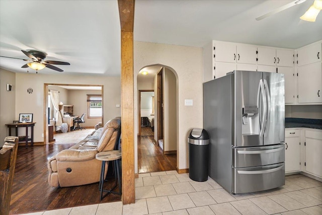 304 W Elm St, Fairbury, IL 61739 - kitchen with stainless steel fridge with ice dispenser, ceiling fan, arched walkways, and white cabinets