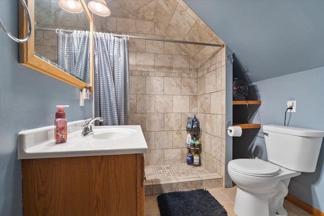 304 W Elm St, Fairbury, IL 61739 - bathroom with a tile shower, toilet, vanity, vaulted ceiling, and tile patterned floors