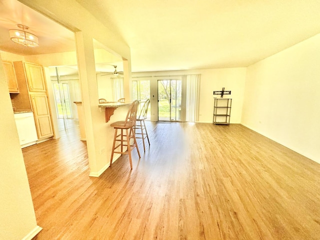 interior space with light wood-type flooring and a ceiling fan