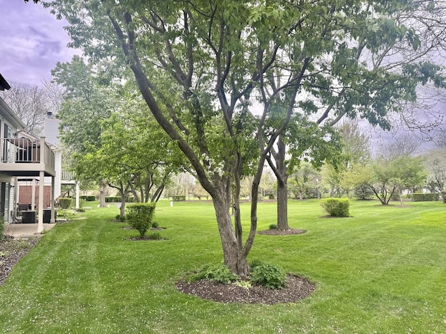 view of yard with cooling unit and a deck