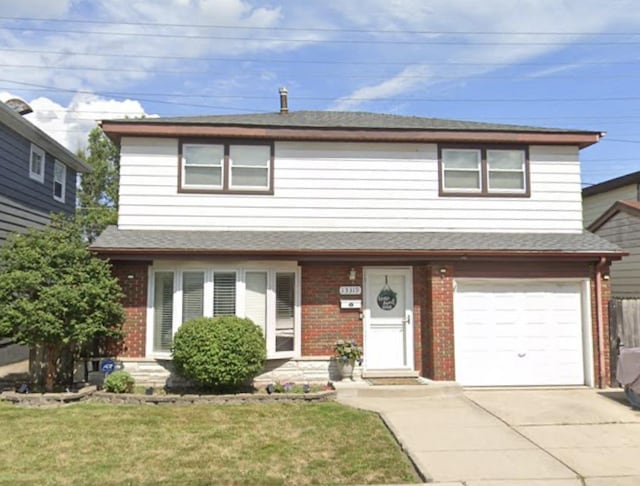 13319 S Mackinaw Ave, Chicago, IL 60633 - traditional-style house featuring driveway, brick siding, a front lawn, and an attached garage