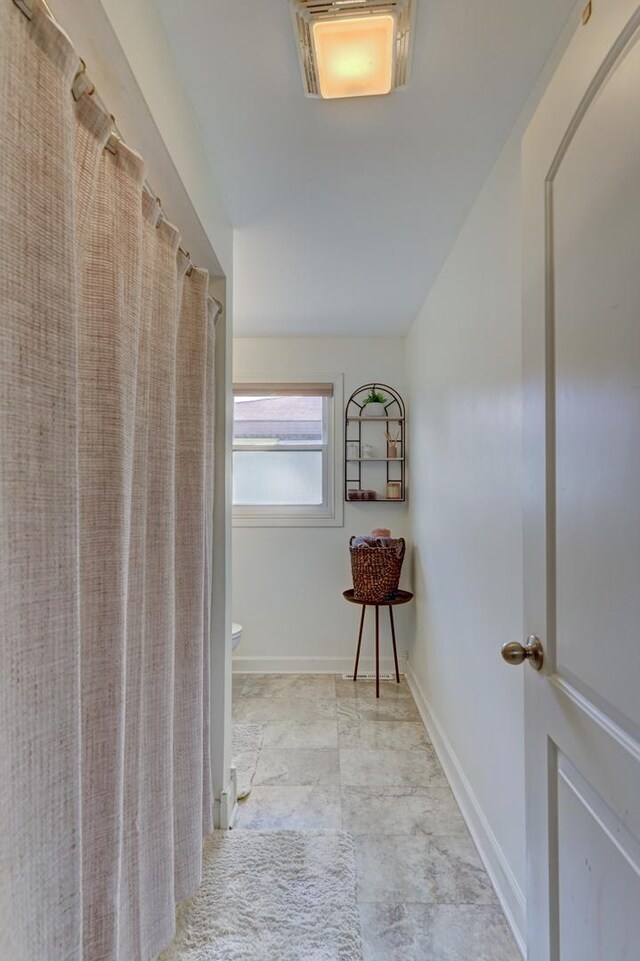 13319 S Mackinaw Ave, Chicago, IL 60633 - hallway featuring baseboards and vaulted ceiling