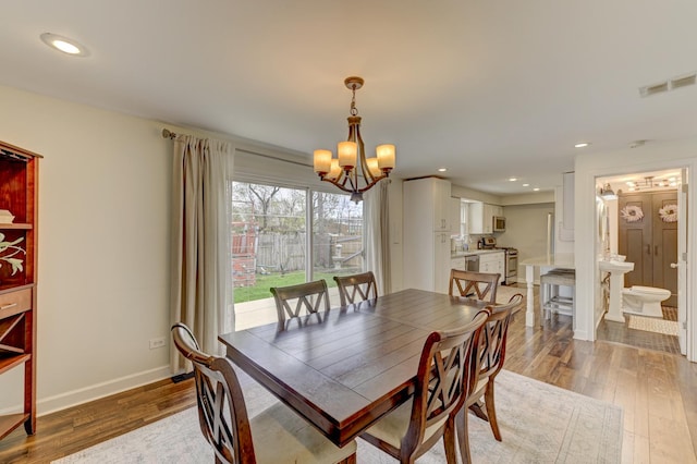 13319 S Mackinaw Ave, Chicago, IL 60633 - dining space with recessed lighting, light wood-style floors, an inviting chandelier, and visible vents