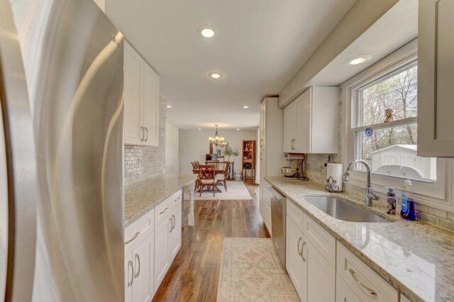 13319 S Mackinaw Ave, Chicago, IL 60633 - kitchen with white cabinetry, tasteful backsplash, appliances with stainless steel finishes, and a sink