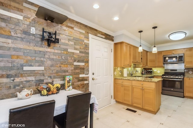 kitchen featuring stainless steel appliances, ornamental molding, a sink, light stone countertops, and decorative light fixtures