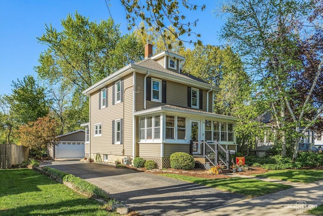 759 E Wilson St, Batavia, IL 60510 - american foursquare style home with an outbuilding, a detached garage, a chimney, and fence