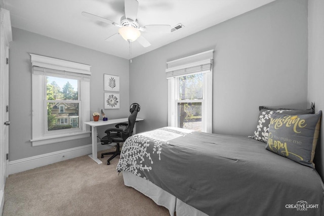 759 E Wilson St, Batavia, IL 60510 - carpeted bedroom featuring multiple windows, a desk, ceiling fan, and baseboards