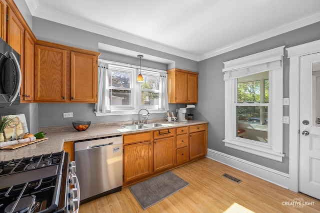 759 E Wilson St, Batavia, IL 60510 - kitchen with a sink, appliances with stainless steel finishes, brown cabinets, and ornamental molding