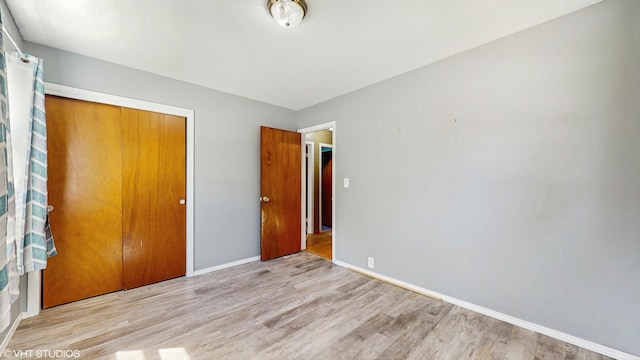 121 Northern Ter, Island Lake, IL 60042 - unfurnished bedroom with wood finished floors, baseboards, and a closet