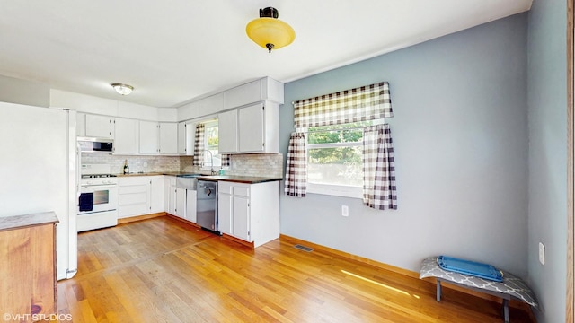 121 Northern Ter, Island Lake, IL 60042 - kitchen featuring stainless steel appliances, tasteful backsplash, light wood-style floors, a sink, and white cabinets