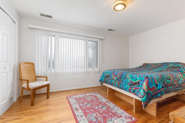 5657 N Crescent Ave, Norwood Park, IL 60631 - bedroom with baseboards, a closet, visible vents, and wood finished floors