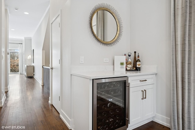 indoor dry bar featuring beverage cooler, a heating unit, dark wood finished floors, baseboards, and recessed lighting