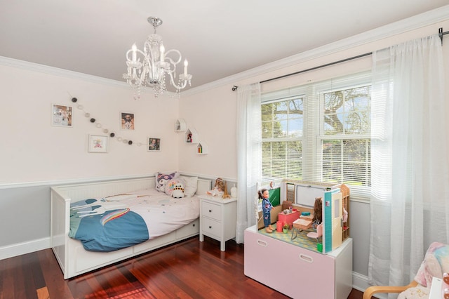 bedroom with ornamental molding, a notable chandelier, and wood finished floors