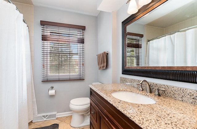 bathroom with healthy amount of natural light, vanity, baseboards, and toilet