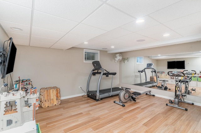 workout area with recessed lighting, baseboards, and wood finished floors