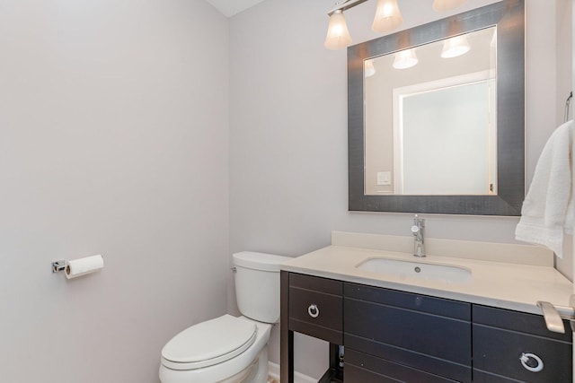 bathroom with toilet and vanity