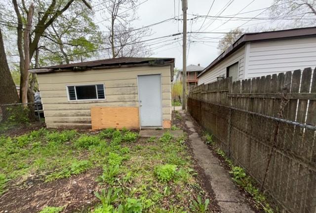 view of shed featuring fence