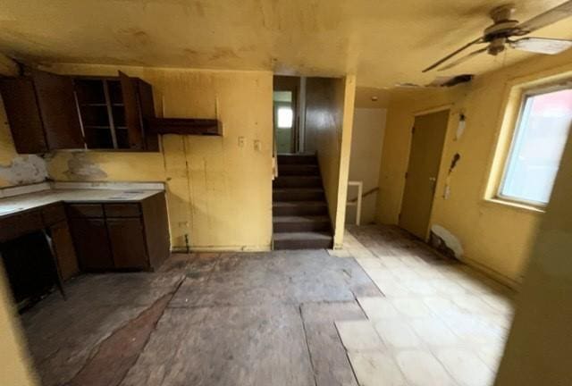 kitchen with light countertops and a ceiling fan