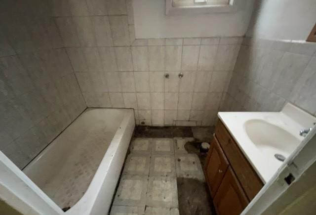 full bathroom with a shower, tile walls, vanity, and a bathtub
