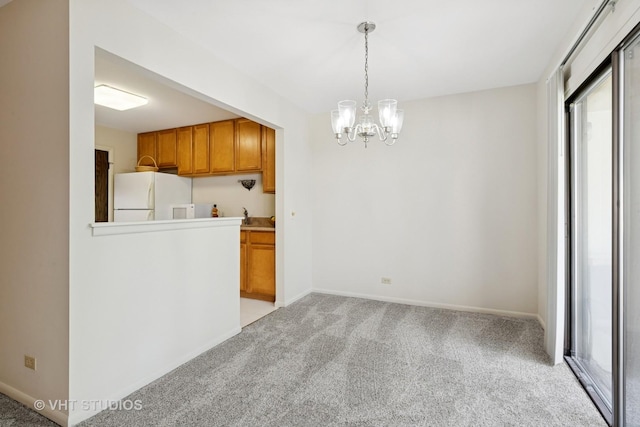 584 Williamsburg Ct Unit C2, Wheeling, IL 60090 - kitchen with freestanding refrigerator, light colored carpet, a chandelier, brown cabinetry, and hanging light fixtures