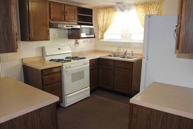 kitchen with a sink, open shelves, white appliances, under cabinet range hood, and light countertops