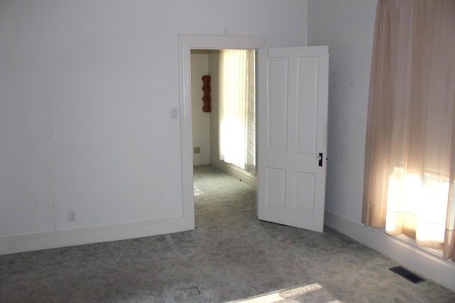 empty room with carpet flooring and visible vents