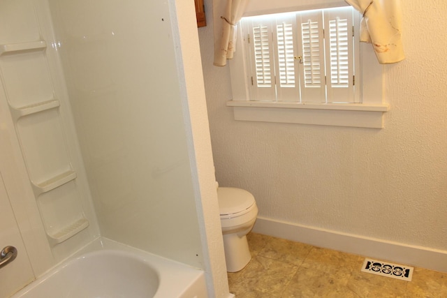 bathroom with toilet and washtub / shower combination