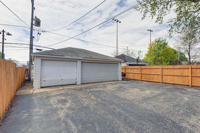 detached garage featuring fence