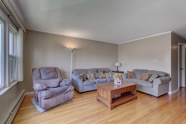 living area featuring baseboard heating, light wood-style flooring, ornamental molding, and baseboards