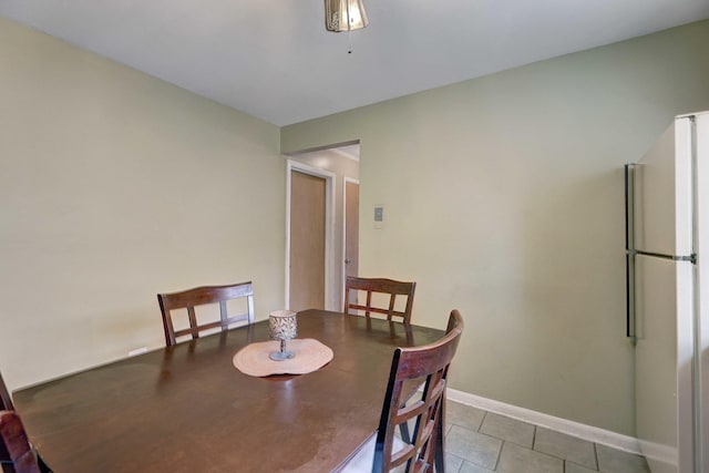 dining area featuring tile patterned floors and baseboards