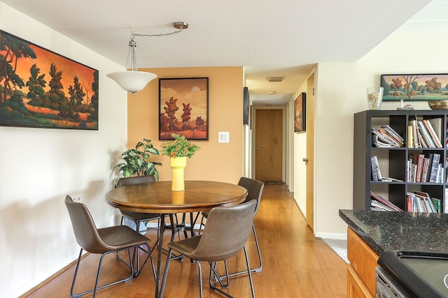 5300 Walnut Ave Unit 4D, Downers Grove, IL 60515 - dining room featuring light wood-style floors, visible vents, and baseboards
