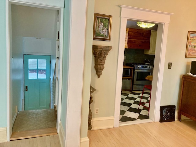 hall featuring wood finished floors and baseboards